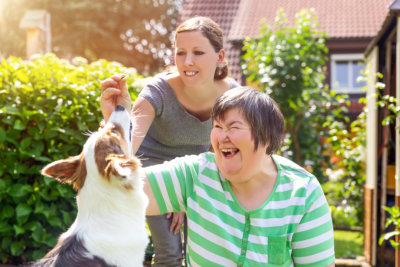 women playing with dog