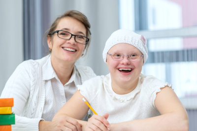 teacher and girl smiling