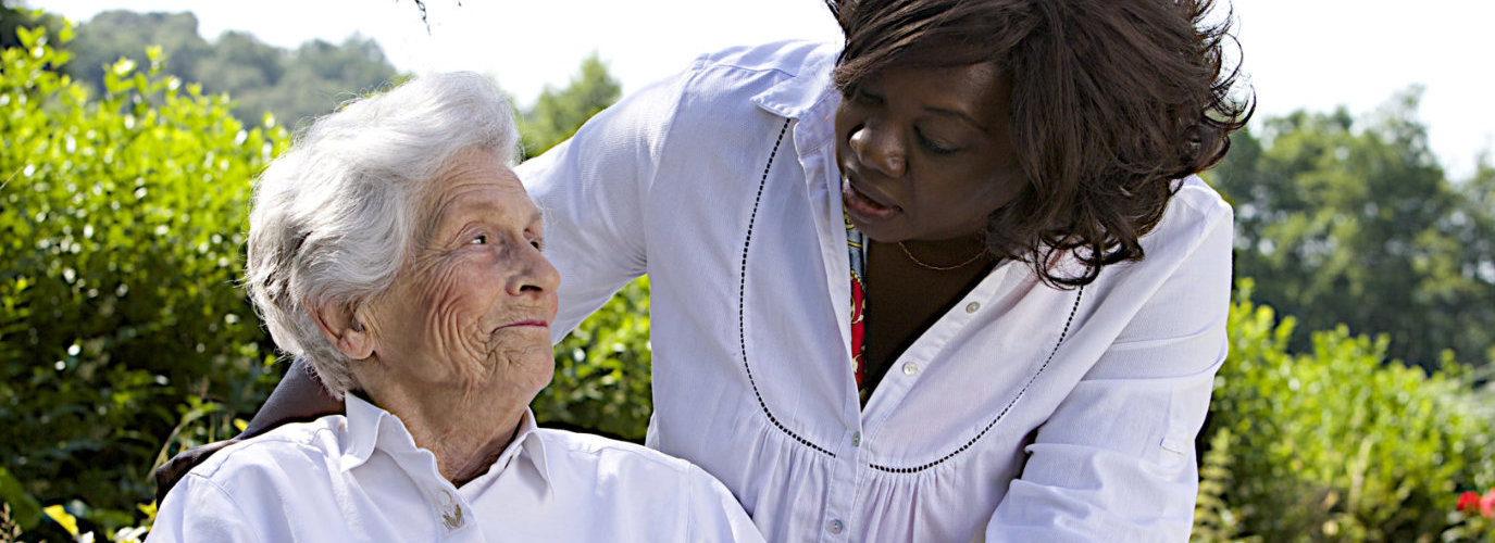 senior woman and caregiver looking at each other